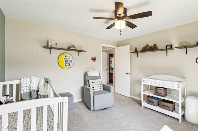 carpeted bedroom with a ceiling fan and baseboards