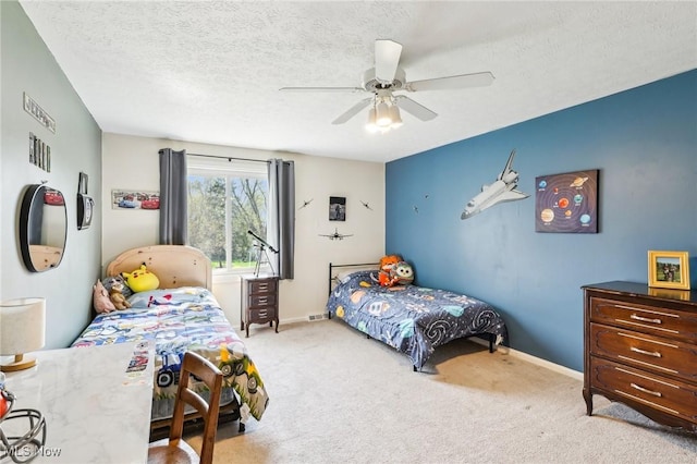 bedroom featuring baseboards, ceiling fan, and carpet flooring