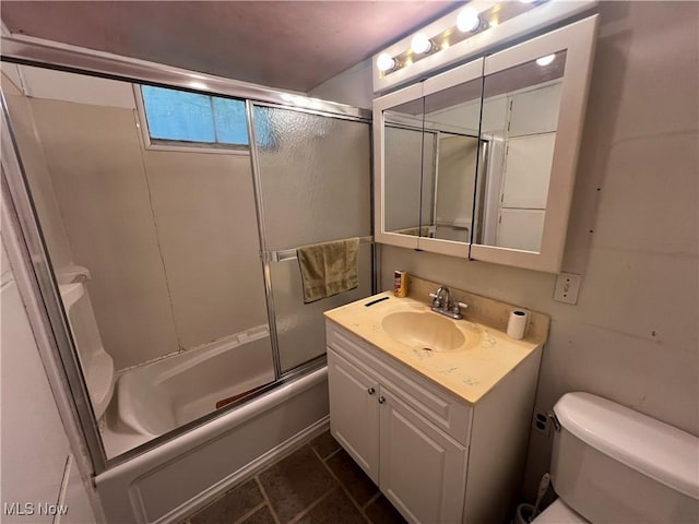 bathroom with toilet, shower / bath combination with glass door, and vanity