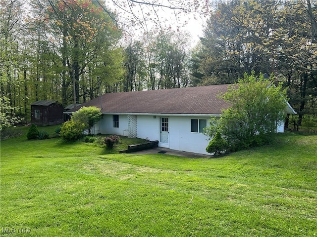 rear view of house featuring a yard