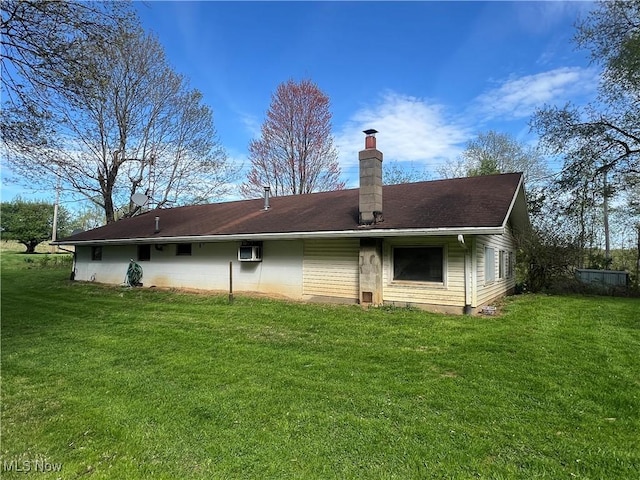 rear view of house with a lawn and a chimney