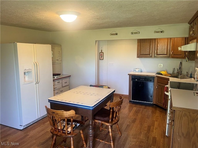 kitchen with dishwasher, a textured ceiling, dark wood finished floors, white fridge with ice dispenser, and under cabinet range hood