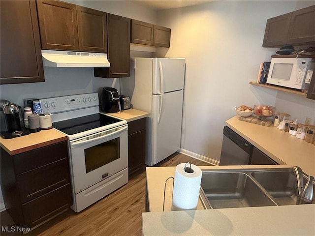 1173 Red Tail Hawk Ct Unit 4, Youngstown, OH 44512 - kitchen featuring dark brown cabinetry, wood finished floors, light countertops, under cabinet range hood, and white appliances