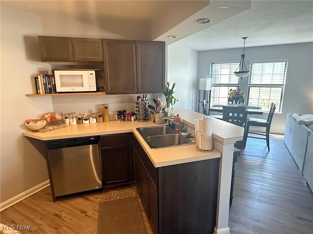 1173 Red Tail Hawk Ct Unit 4, Youngstown, OH 44512 - kitchen featuring stainless steel dishwasher, a peninsula, white microwave, light countertops, and a sink