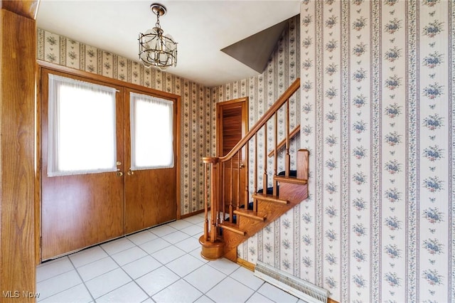 foyer entrance with french doors, baseboards, wallpapered walls, light tile patterned floors, and stairway