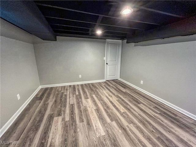 finished below grade area with baseboards, recessed lighting, and wood finished floors