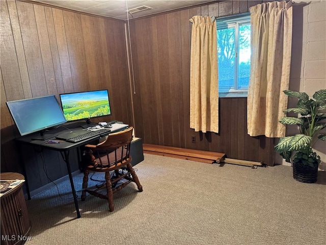 home office with wooden walls, carpet flooring, and visible vents