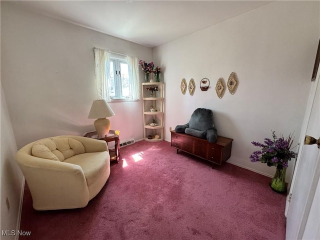 living area with baseboards and carpet