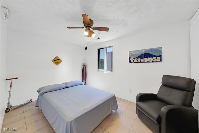 bedroom with baseboards, ceiling fan, and light tile patterned flooring