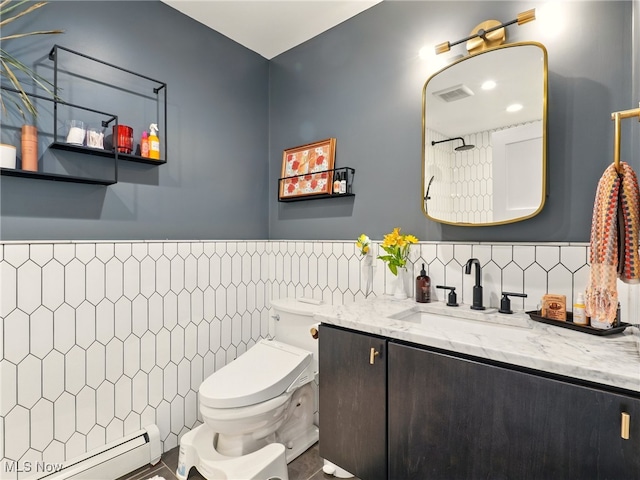 bathroom featuring vanity, visible vents, toilet, tile walls, and a baseboard radiator