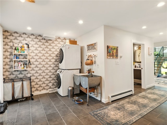 miscellaneous room with recessed lighting, baseboards, baseboard heating, and stacked washer and clothes dryer
