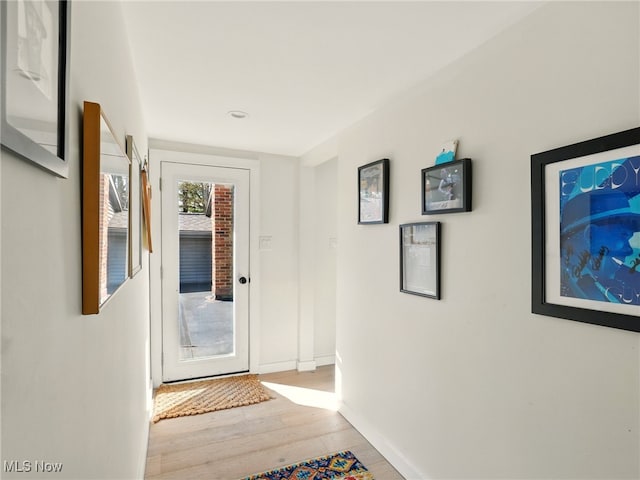16165 Thompson Rd, Thompson, OH 44086 - doorway with baseboards and wood finished floors