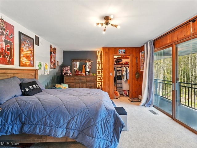 16165 Thompson Rd, Thompson, OH 44086 - bedroom featuring carpet, access to exterior, wooden walls, a closet, and a walk in closet