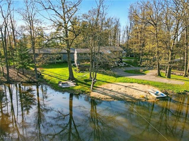 view of community featuring a lawn and a water view