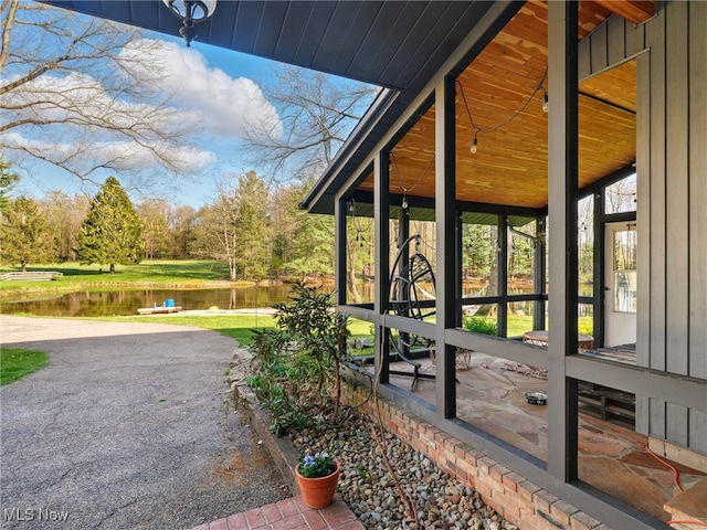 view of property exterior with a water view