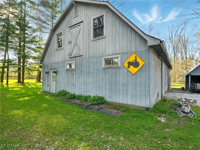 view of side of home with a yard