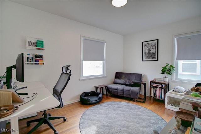 office area with a healthy amount of sunlight and light wood-style flooring