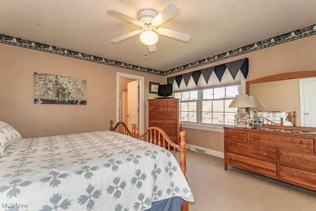bedroom with baseboards, ceiling fan, and light carpet