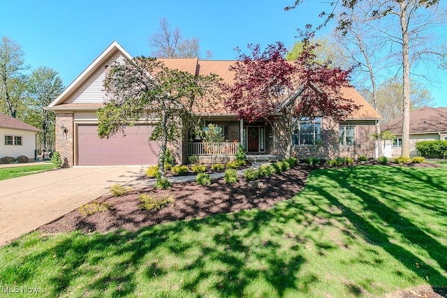 view of front of home featuring a front lawn, brick siding, an attached garage, driveway, and a porch