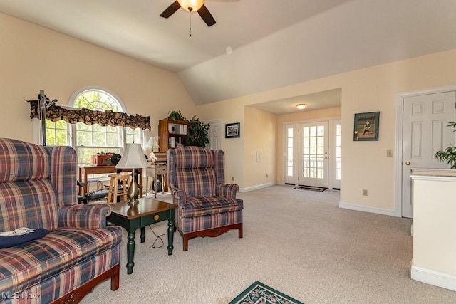 interior space featuring carpet flooring, a ceiling fan, baseboards, and lofted ceiling