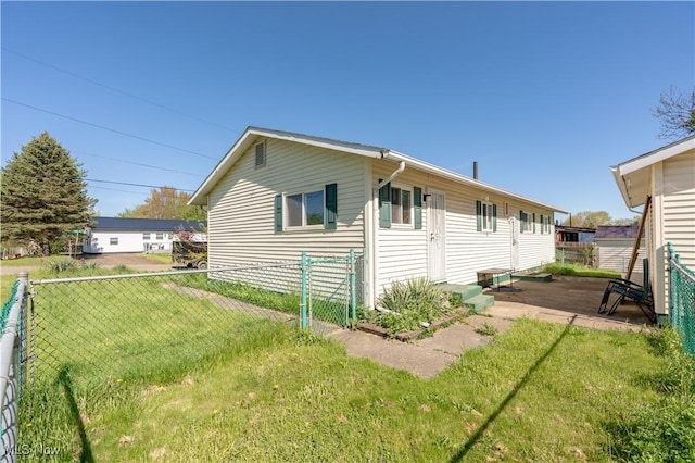 back of property with a lawn and a fenced backyard