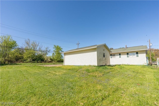 back of property featuring a yard