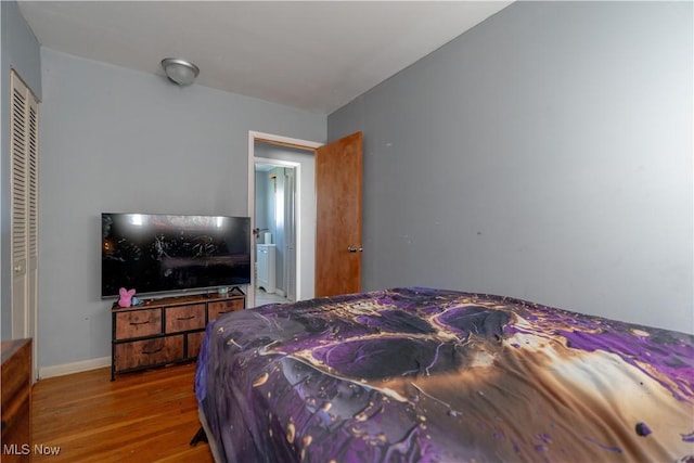 bedroom with baseboards and wood finished floors