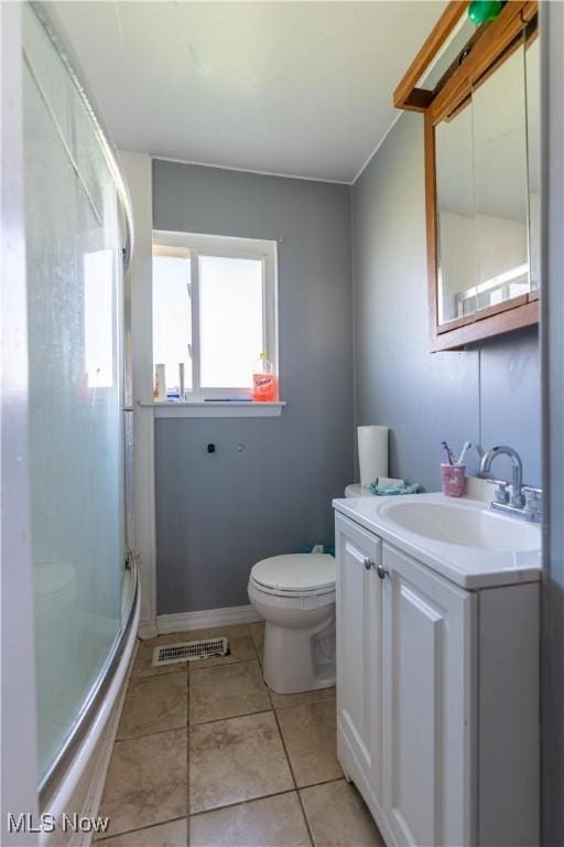 full bathroom with tile patterned flooring, vanity, toilet, a shower stall, and visible vents