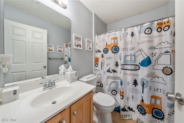 bathroom with vanity, curtained shower, toilet, a textured ceiling, and tile patterned floors