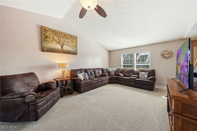 carpeted living room featuring a textured ceiling, ceiling fan, and vaulted ceiling