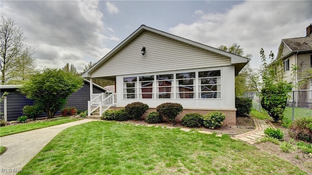 1423 N Wooster Ave, Dover, OH 44622 - rear view of house with a lawn and fence