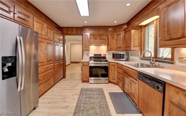 1423 N Wooster Ave, Dover, OH 44622 - kitchen with a sink, light wood finished floors, appliances with stainless steel finishes, and light countertops
