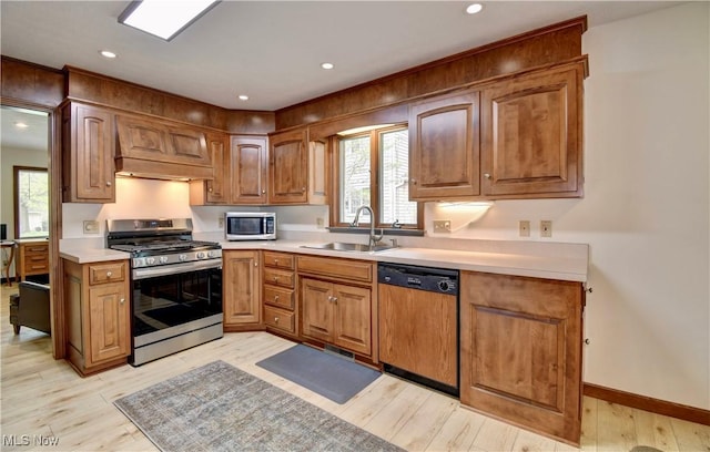 1423 N Wooster Ave, Dover, OH 44622 - kitchen featuring stainless steel appliances, custom exhaust hood, a sink, and light wood-style flooring
