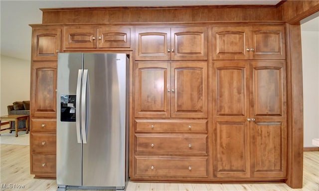 1423 N Wooster Ave, Dover, OH 44622 - kitchen with stainless steel refrigerator with ice dispenser, brown cabinetry, and light wood finished floors
