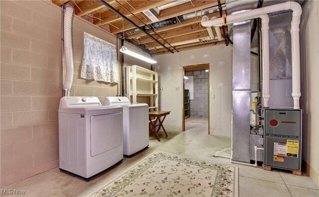 1423 N Wooster Ave, Dover, OH 44622 - laundry room with heating unit, concrete block wall, laundry area, and washing machine and clothes dryer