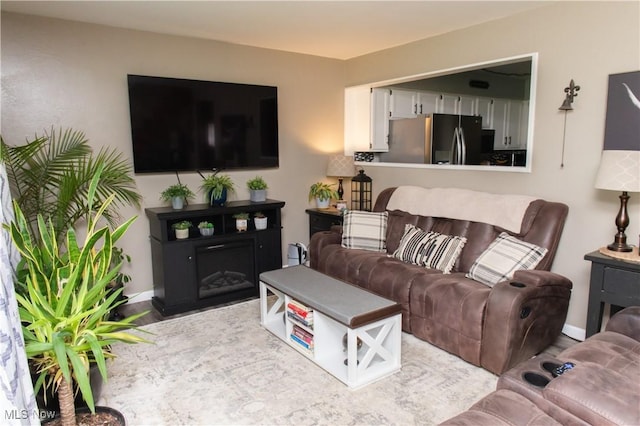 living room featuring baseboards and wood finished floors
