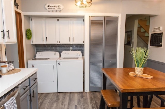 laundry room with cabinet space, dark wood finished floors, and independent washer and dryer