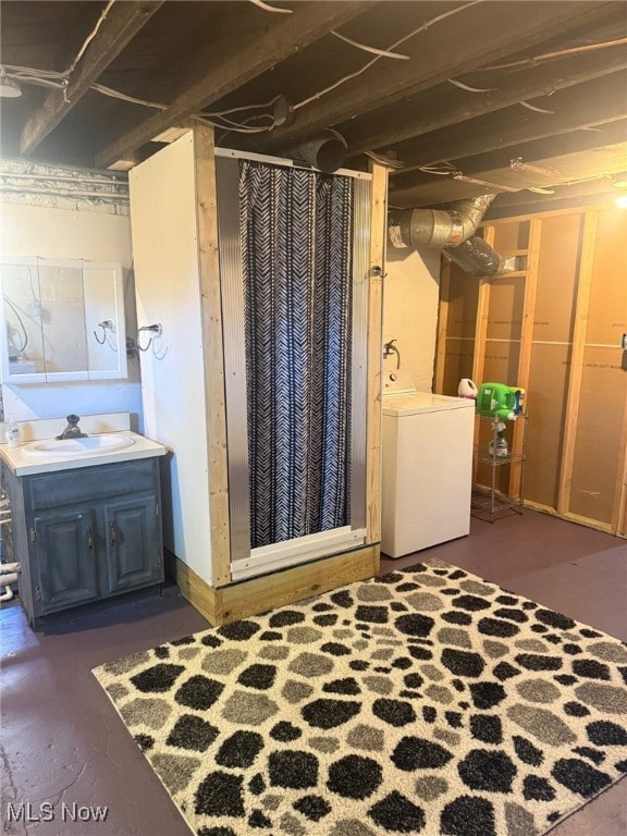 unfinished basement featuring washer / dryer and a sink