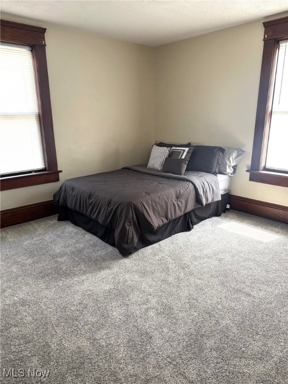 bedroom with carpet flooring and baseboards