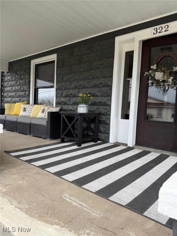 property entrance with stone siding