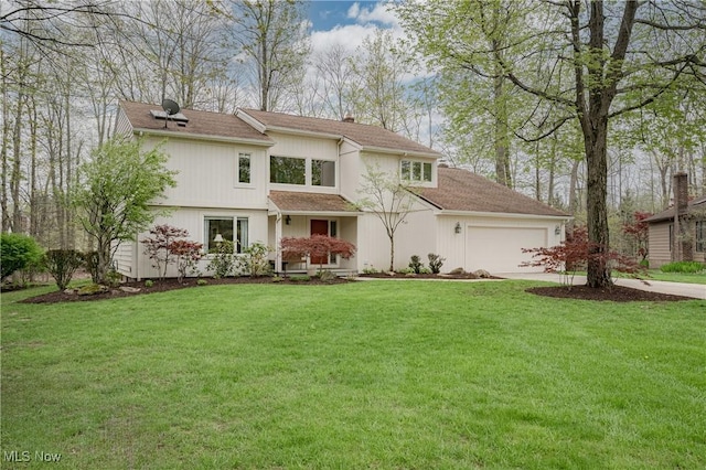 traditional home featuring concrete driveway, an attached garage, a chimney, and a front yard