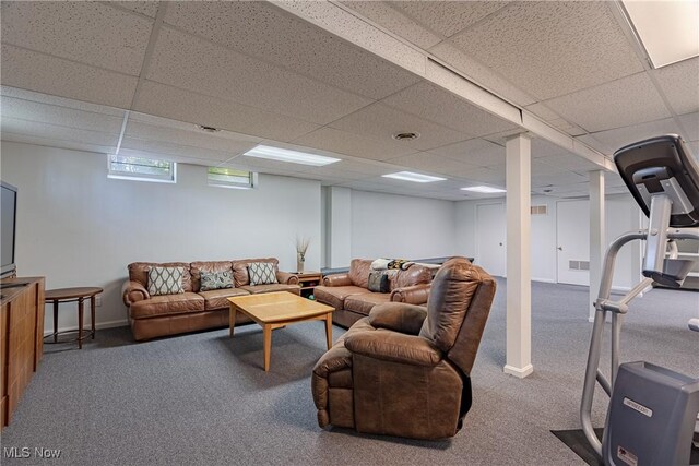 carpeted living room featuring visible vents and a drop ceiling