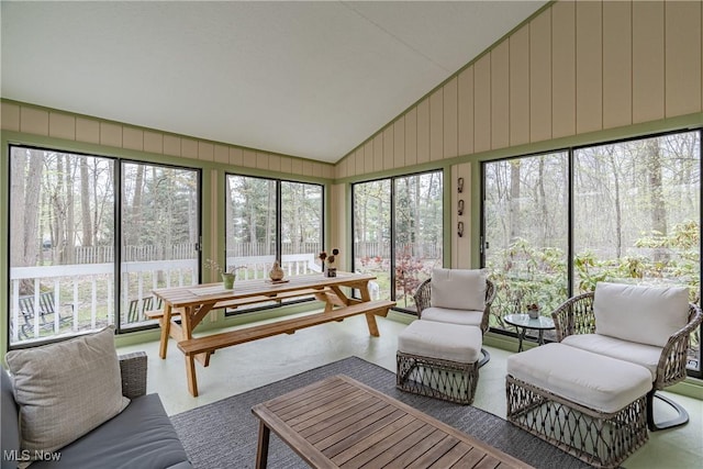 sunroom / solarium featuring lofted ceiling
