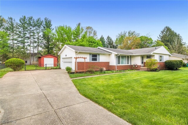 ranch-style home with driveway, brick siding, fence, a front lawn, and an attached garage