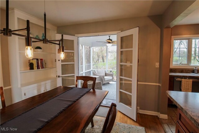 dining room featuring ceiling fan and wood finished floors