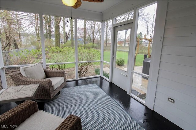 sunroom featuring ceiling fan