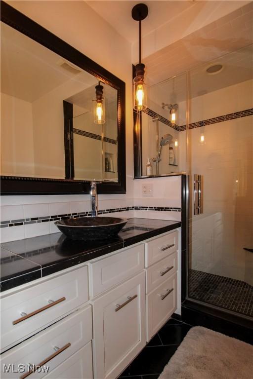 full bathroom with vanity, tile patterned floors, and a shower stall