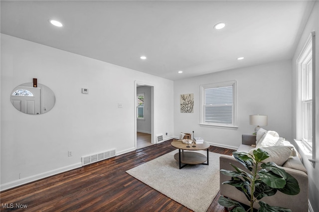 living area with visible vents, recessed lighting, baseboards, and wood finished floors