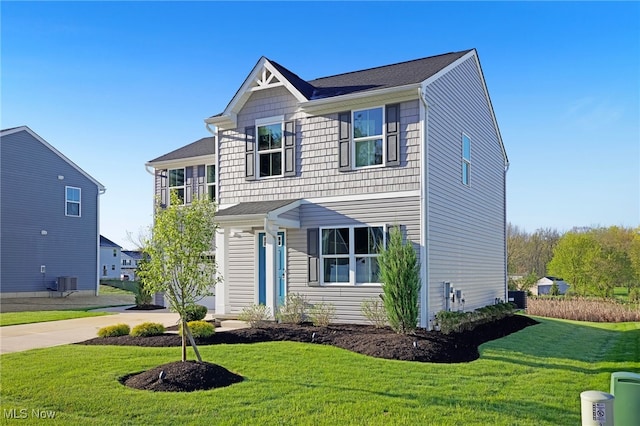 traditional-style home featuring central air condition unit and a front yard