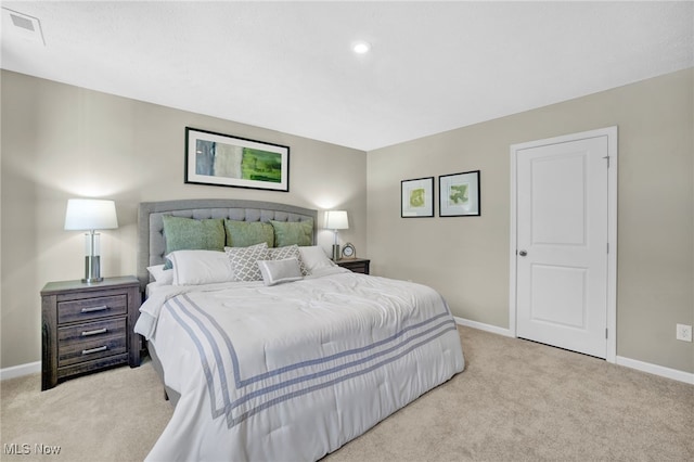 bedroom featuring baseboards, visible vents, and carpet
